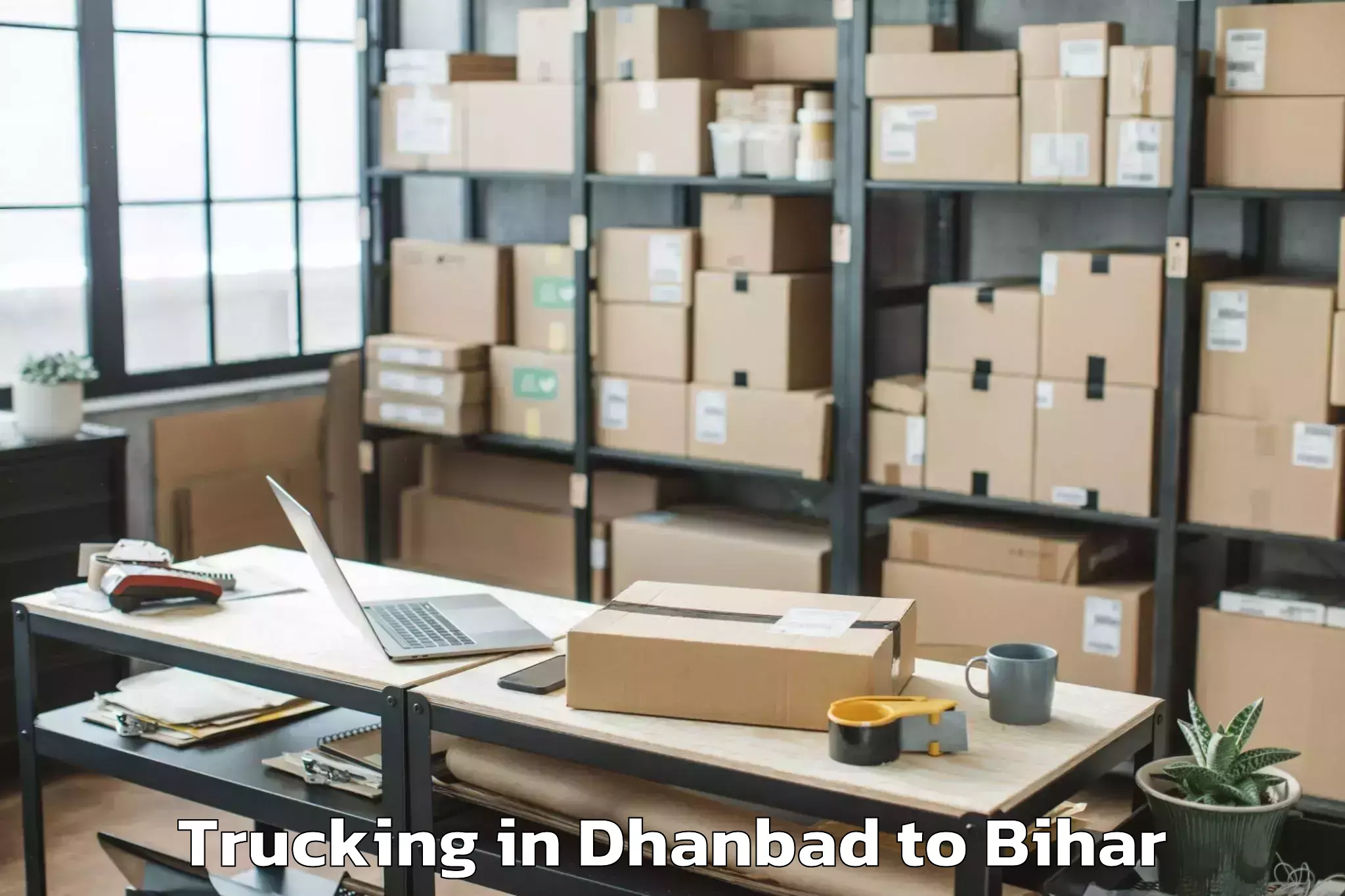 Easy Dhanbad to Wazirganj Trucking Booking